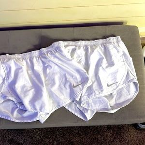 2 white pairs of nike shorts